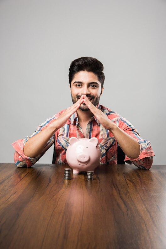 [freepicdownloader.com]-indian-man-with-piggy-bank-sitting-table-medium(1).jpg